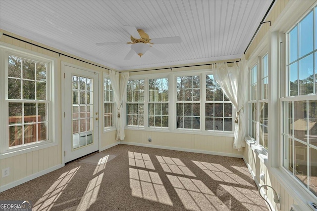 unfurnished sunroom featuring a ceiling fan