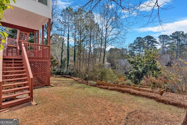 view of yard with stairs and a deck