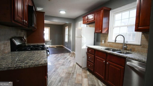4681 City View Dr, Forest Park, GA 30297 - kitchen featuring appliances with stainless steel finishes, a fireplace, a sink, and dark brown cabinets