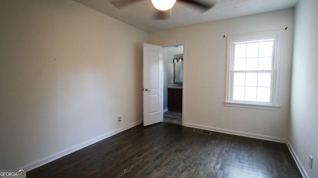 4681 City View Dr, Forest Park, GA 30297 - unfurnished bedroom featuring a ceiling fan, visible vents, baseboards, and dark wood-style flooring
