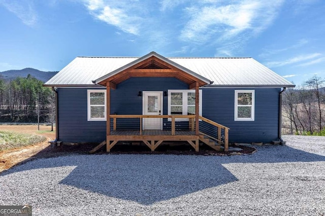 view of front facade featuring a mountain view and metal roof