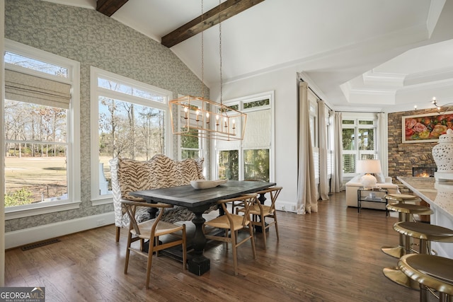 dining area with dark wood-style flooring, vaulted ceiling with beams, a notable chandelier, visible vents, and baseboards