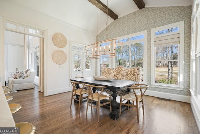 dining space with beamed ceiling, wood finished floors, visible vents, and baseboards