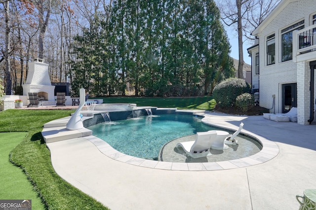 outdoor pool featuring a patio and an outdoor fireplace