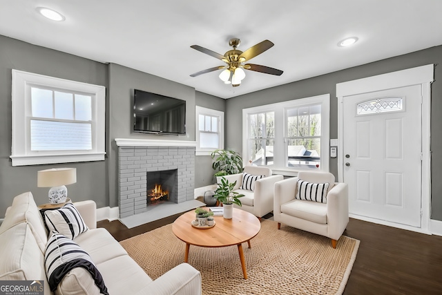 2006 Conrad Ave SE, Atlanta, GA 30315 - living room featuring baseboards, a brick fireplace, a ceiling fan, dark wood finished floors, and recessed lighting