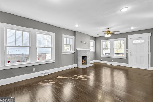 2006 Conrad Ave SE, Atlanta, GA 30315 - unfurnished living room with baseboards, visible vents, ceiling fan, a healthy amount of sunlight, and wood finished floors