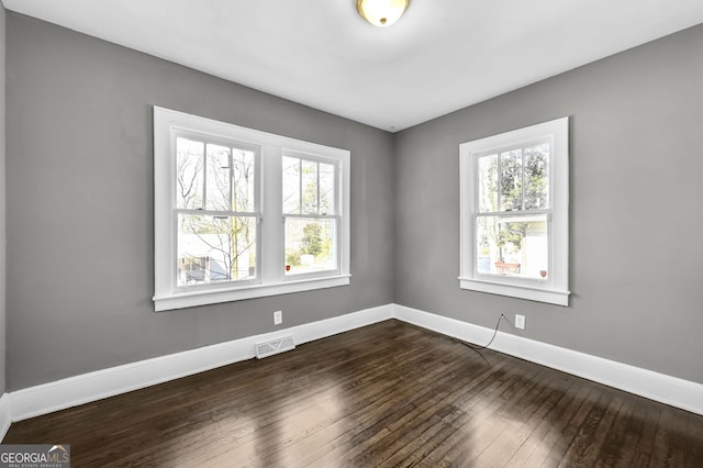 2006 Conrad Ave SE, Atlanta, GA 30315 - spare room featuring dark wood-type flooring, visible vents, a wealth of natural light, and baseboards