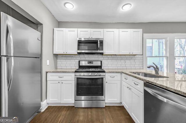 2006 Conrad Ave SE, Atlanta, GA 30315 - kitchen featuring a sink, white cabinets, dark wood-style flooring, and stainless steel appliances