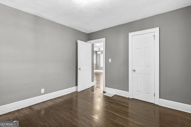 unfurnished bedroom featuring wood finished floors and baseboards