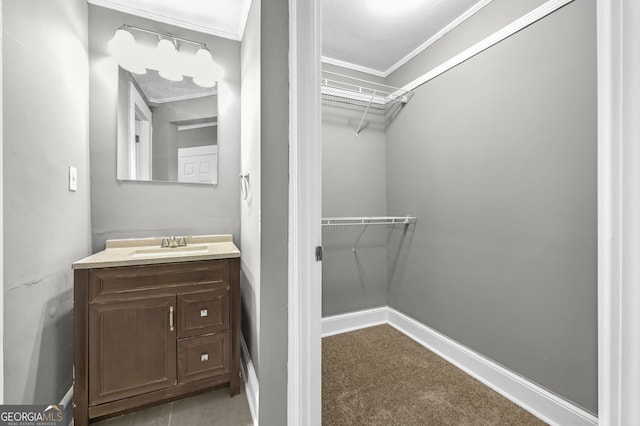 walk in closet with carpet floors and a sink