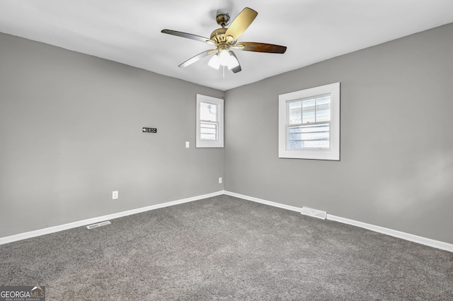 2006 Conrad Ave SE, Atlanta, GA 30315 - spare room with visible vents, baseboards, dark carpet, and ceiling fan