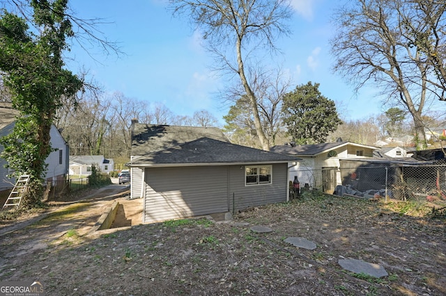 back of house featuring fence