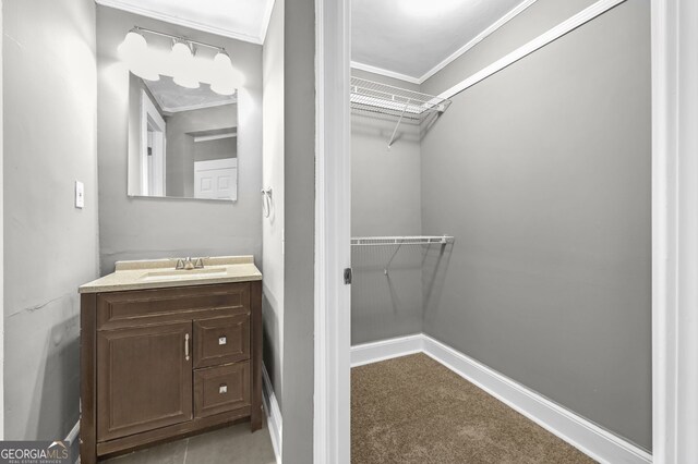 2006 Conrad Ave SE, Atlanta, GA 30315 - bathroom featuring vanity, baseboards, ornamental molding, and a spacious closet