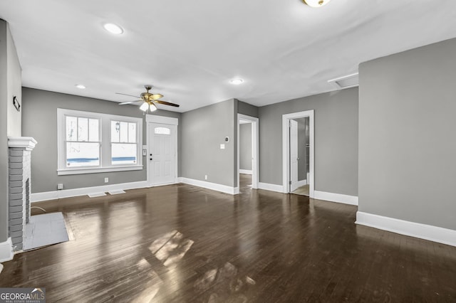 unfurnished living room featuring recessed lighting, a brick fireplace, ceiling fan, wood finished floors, and baseboards