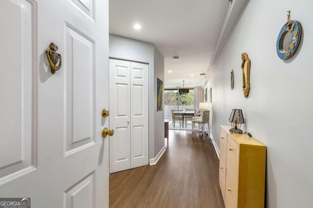 hall with recessed lighting, baseboards, and wood finished floors