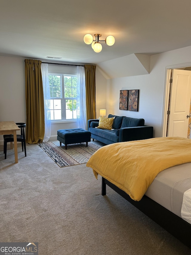 bedroom featuring light carpet, lofted ceiling, and visible vents