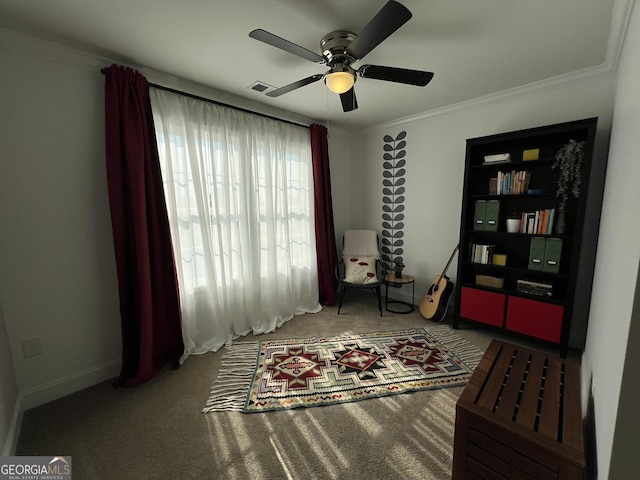 interior space with carpet floors, a ceiling fan, visible vents, and crown molding