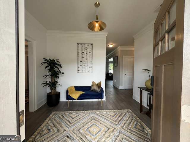 interior space with baseboards, crown molding, and wood finished floors