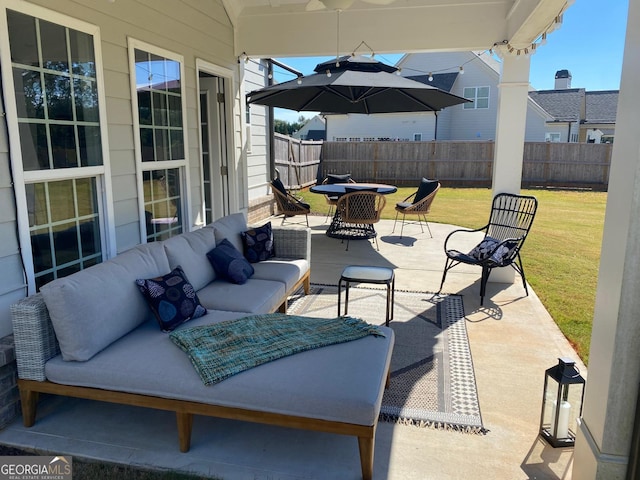 view of patio with outdoor dining area, outdoor lounge area, and fence