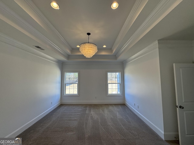 carpeted empty room with baseboards, crown molding, visible vents, and a tray ceiling