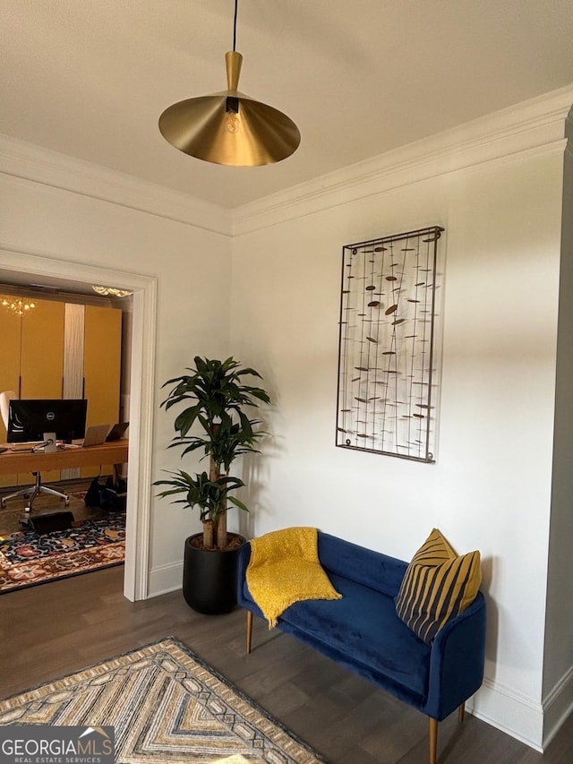 sitting room with ornamental molding, wood finished floors, and baseboards