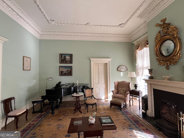 living room with crown molding, a fireplace, and wood finished floors