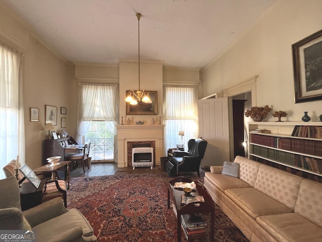 living area featuring a chandelier and a fireplace