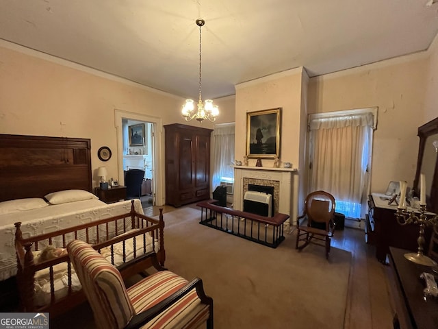 carpeted bedroom featuring a chandelier, a tile fireplace, and crown molding