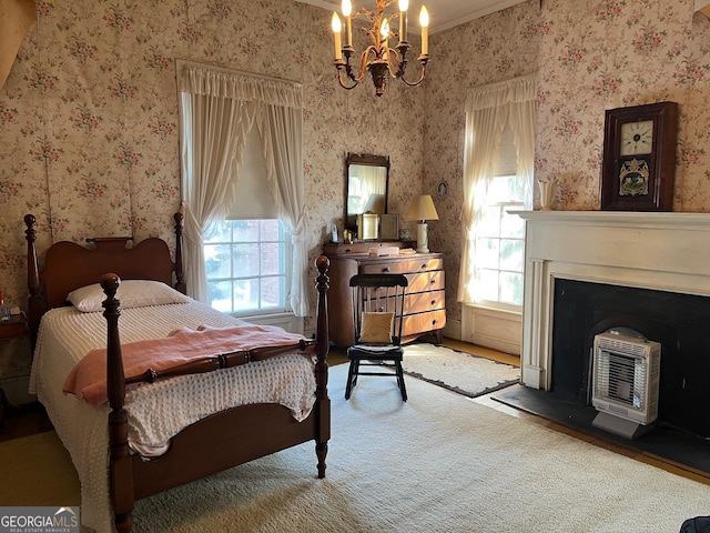 bedroom with a chandelier, heating unit, and wallpapered walls