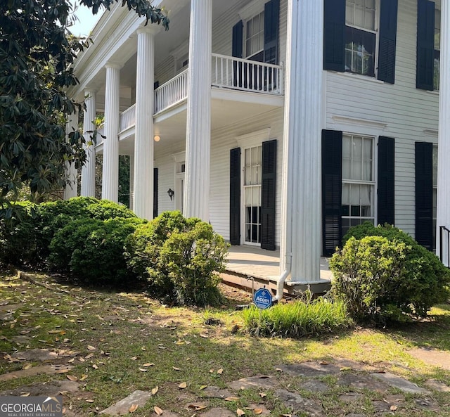 view of side of property with a porch