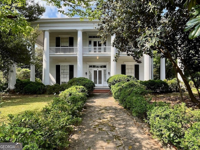 neoclassical / greek revival house featuring french doors and a balcony