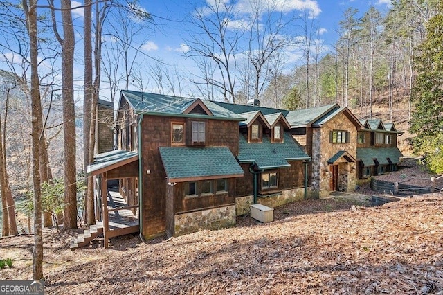 rustic home featuring stone siding