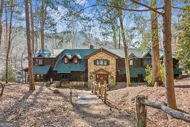 rustic home featuring stone siding