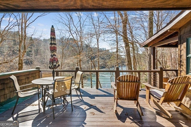 wooden terrace with outdoor dining area