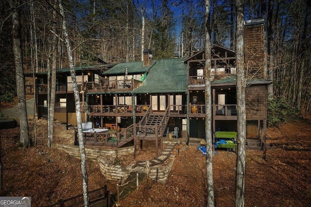 view of playground with stairs and a deck