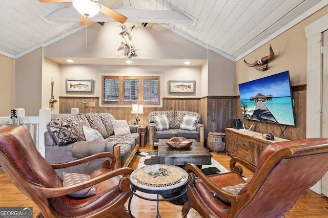 living room featuring wood ceiling, a wainscoted wall, vaulted ceiling, and wooden walls