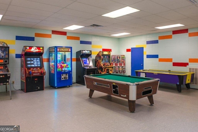 recreation room with visible vents, a drop ceiling, and tile patterned floors