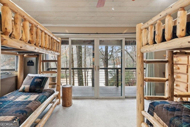 carpeted bedroom with access to outside and wooden ceiling