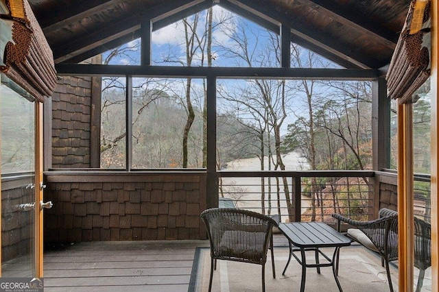 unfurnished sunroom featuring lofted ceiling