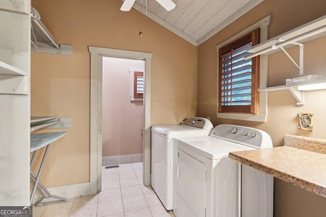 clothes washing area with light tile patterned floors, laundry area, plenty of natural light, and washer and dryer