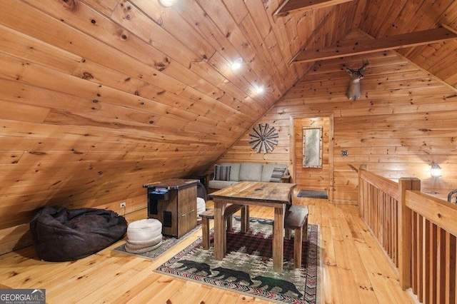 interior space featuring vaulted ceiling, wooden ceiling, wood walls, and hardwood / wood-style floors