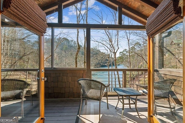 unfurnished sunroom featuring plenty of natural light and vaulted ceiling