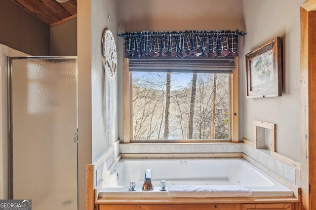 bathroom featuring a stall shower and a garden tub