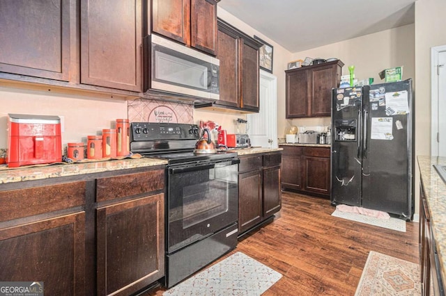 kitchen with light stone counters, dark brown cabinets, decorative backsplash, dark wood-style floors, and black appliances