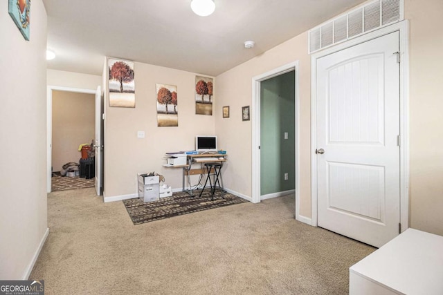 carpeted office space featuring visible vents and baseboards