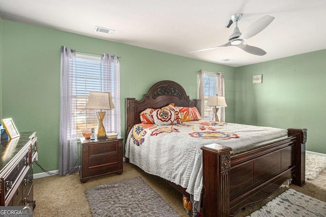 bedroom with carpet floors, ceiling fan, visible vents, and baseboards