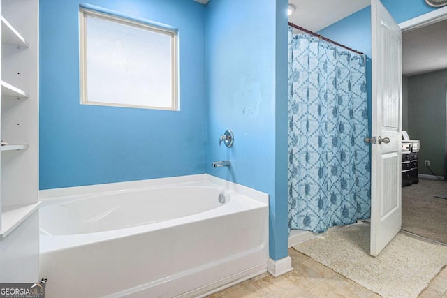 full bathroom with a garden tub, a shower stall, and tile patterned floors