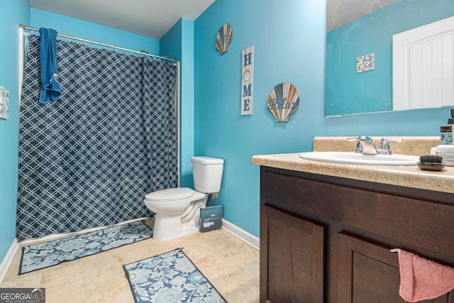 full bathroom with toilet, baseboards, a tile shower, and vanity