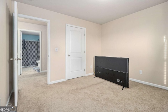 bedroom featuring carpet floors and baseboards