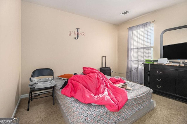 bedroom with carpet flooring, visible vents, and baseboards